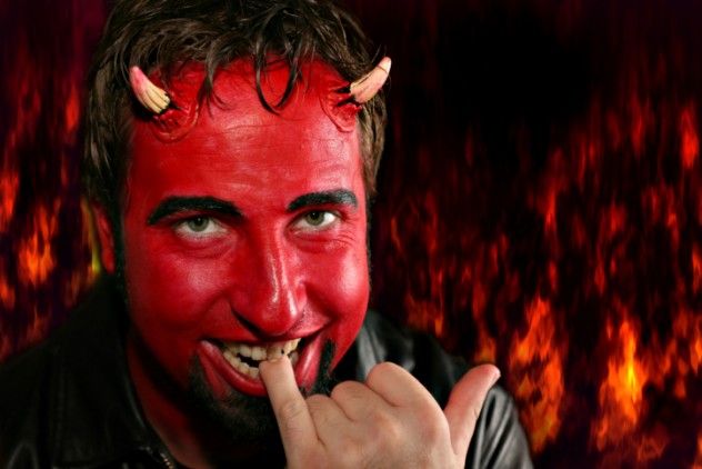 A depiction of a devilish figure biting his pinky finger.