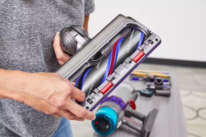 Hands are holding the carpet cleaning attachment for the Dyson Gen5detect Cordless HEPA Vacuum.