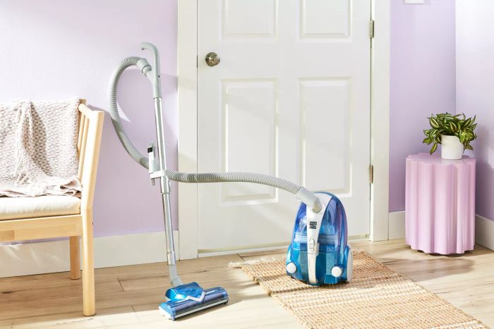 The Kenmore Compact Bagless Canister Vacuum 10701 positioned by a doorway.