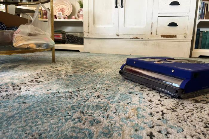 The Dyson 360 Vis Nav Robot Vacuum in action, cleaning a carpeted surface.