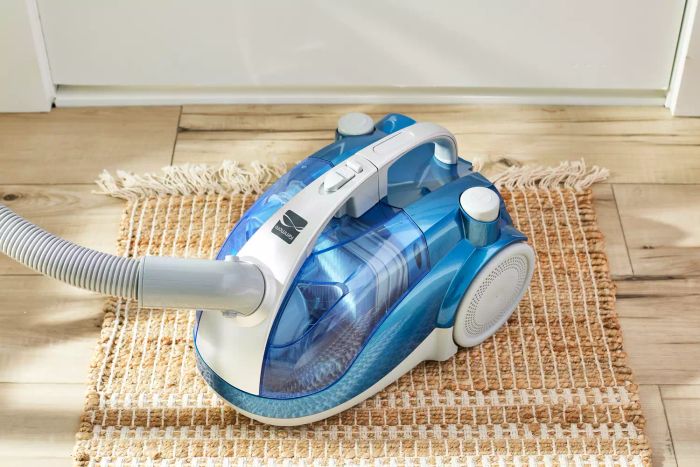 The Kenmore Compact Bagless Canister Vacuum 10701 showcased on a small area rug