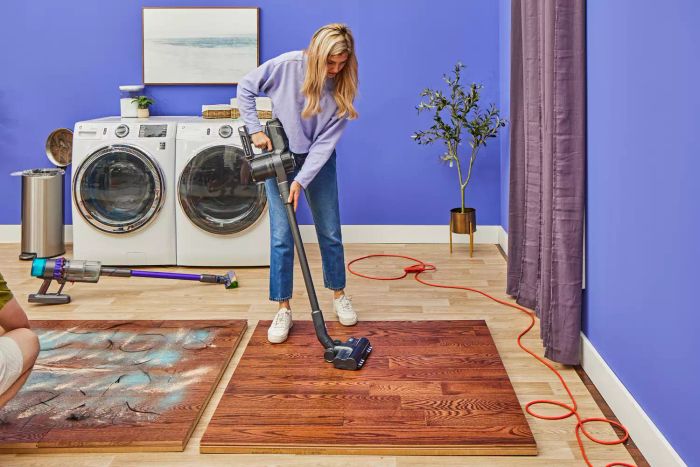 A person finishing the task of cleaning a wooden surface using the Levoit VortexIQ 40 Cordless Stick Vacuum