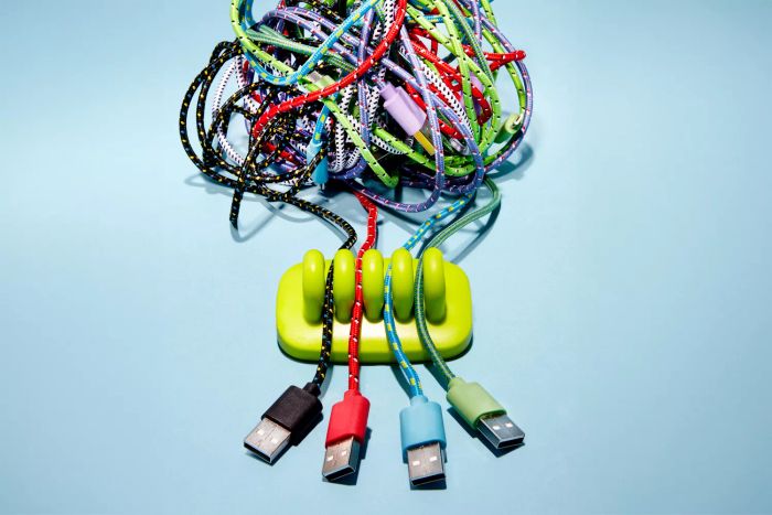 A tangled mess of USB cables inside an organizer.