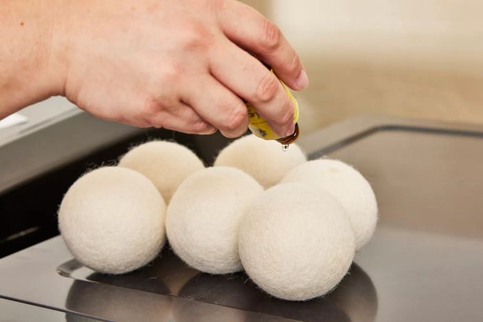 A close-up shot of the Woolzies Organic Wool Dryer Balls resting on top of a dryer.