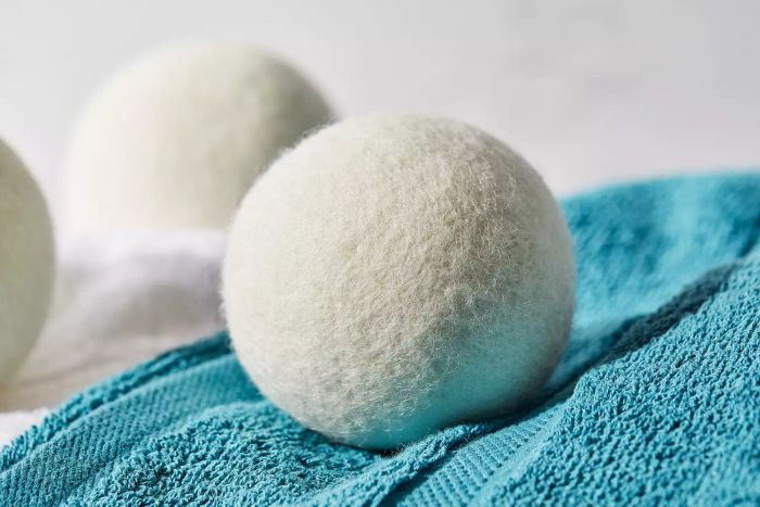 Smart Sheep Wool Dryer Balls placed on a towel.