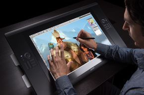 An artist interacting with the Cintiq 24 HD touch graphics tablet.