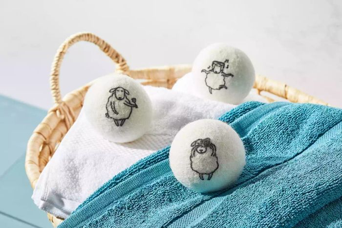 The Kainga Recka Wool Dryer Balls arranged neatly in a woven basket.
