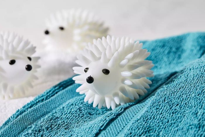 A close-up of the World Market Hedgehog Dryer Balls resting on top of a towel