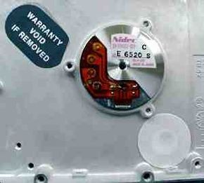 A warning label on a hard disk reads: