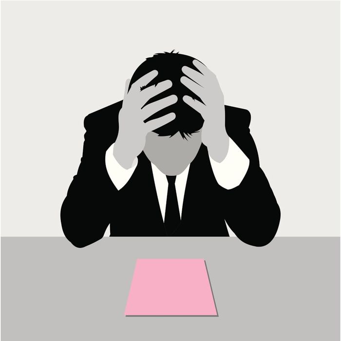 An image of a man holding a pink slip is shown.