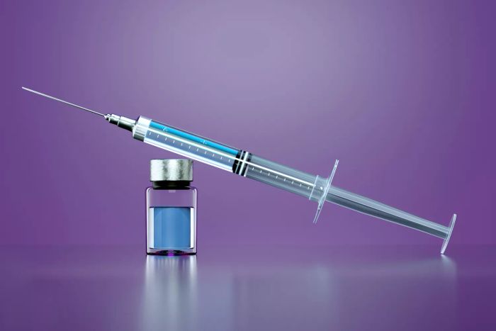 Syringe on a purple background