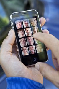An iPhone displaying a contact list.