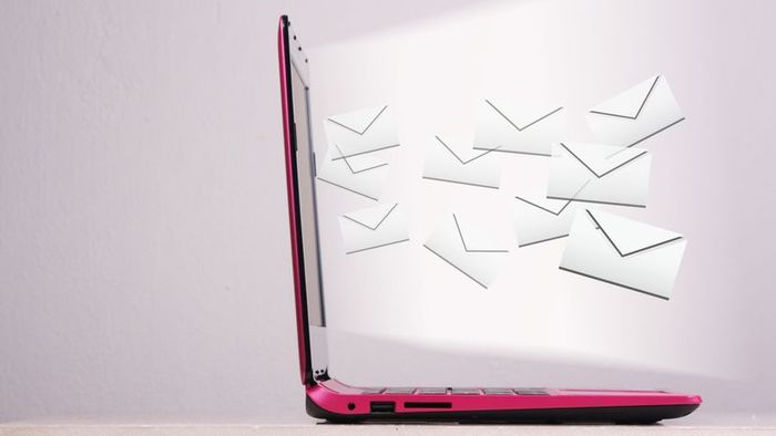 An image of a laptop displaying mail icons emerging from the screen.