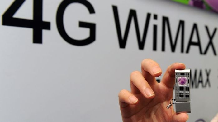 A woman holds a compact silver fourth-generation WiMAX device