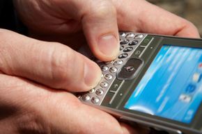 A person typing an SMS message on their phone.