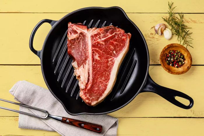 A sizzling steak in a hot pan