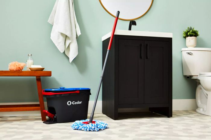 O-Cedar EasyWring RinseClean Spin Mop & Bucket System positioned by a bathroom sink