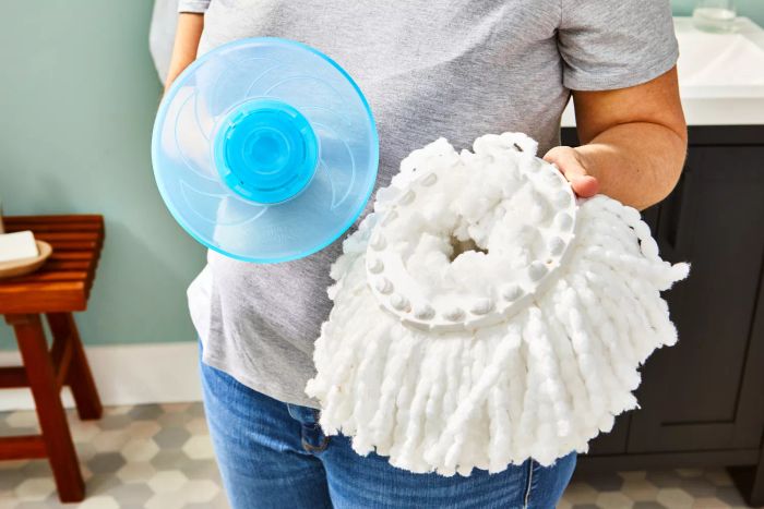 A person lifts the mop head components of the Hurricane Spin Mop.