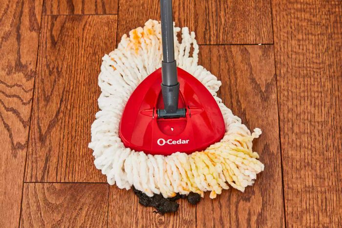 The O-Cedar EasyWring Spin Mop and Bucket System being used to clean a wooden floor