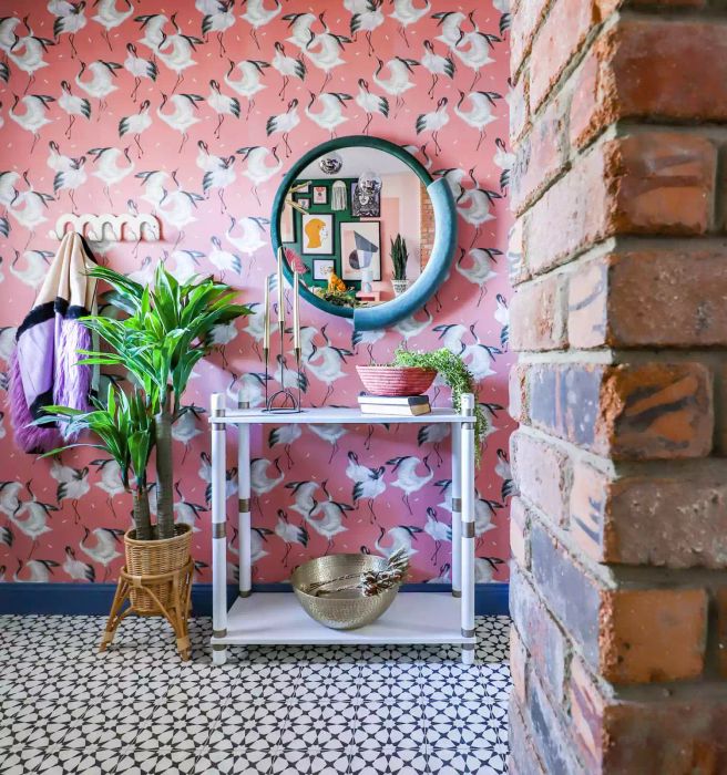 Patterned Pink Wallpaper in the Entryway, Round Mirror, and Slim Console Table
