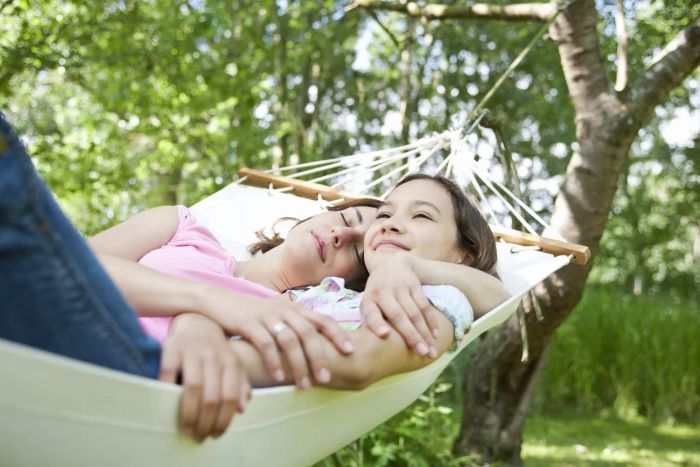 Family resting in a hammock