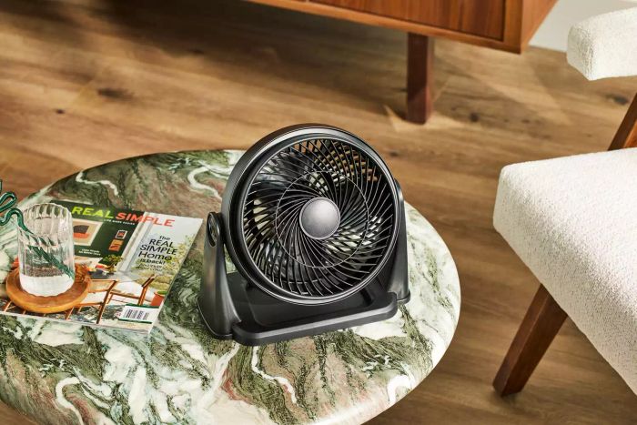 Hampton Bay 9-inch 3-Speed Personal High Velocity Table Fan resting on a coffee table