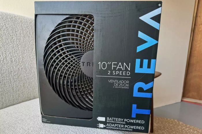 The Treva 10-Inch Portable Fan packaged in a cardboard box before it’s used.