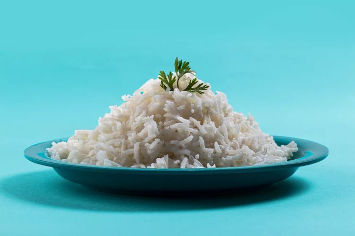 Plain basmati rice with coriander served on a blue plate