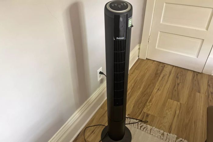 The HOLMES 42 Inch SmartConnect WI-FI Digital Tower Fan plugged into a wall socket