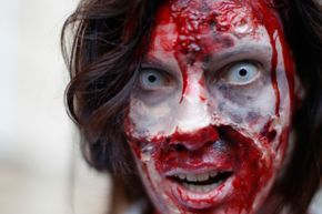 A woman dressed as a zombie staring at the camera