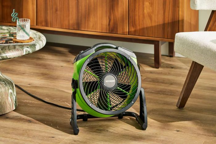 XPOWER FC-200 Whole Room Air Mover placed beside a chair and coffee table
