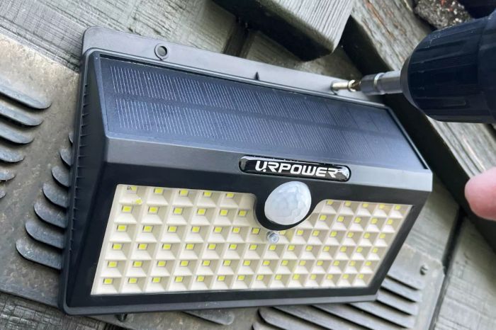 The URPOWER Solar Lights Wireless Motion Sensor Outdoor Light being installed