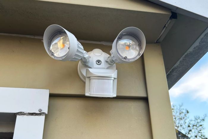 Leonlite LED Outdoor Motion Sensor Flood Light mounted on the side of a house.
