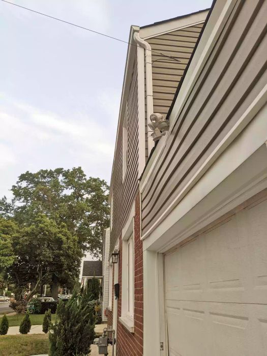 The Maxsa Motion-Activated Dual Head Solar Security Light mounted on a garage roof