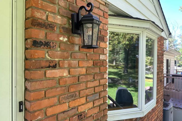 Euri Lighting EFL-130W-MD Flickering Flame Lantern installed on the exterior wall of a home