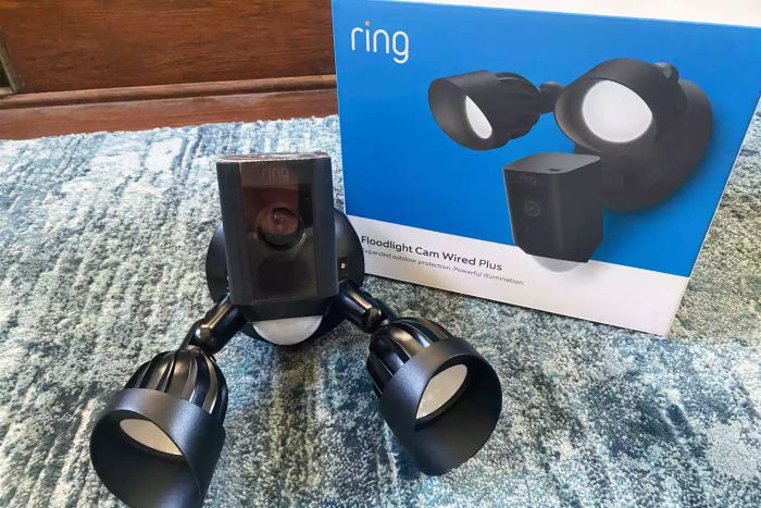 Ring HD Motion-Activated Floodlight Camera along with its packaging placed on carpet