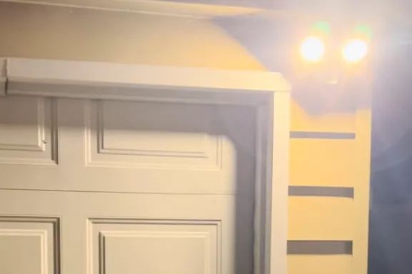 Leonlite LED Outdoor Motion Sensor Flood Light glowing on the side of a house.