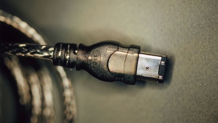 A grey FireWire cable wrapped for protection