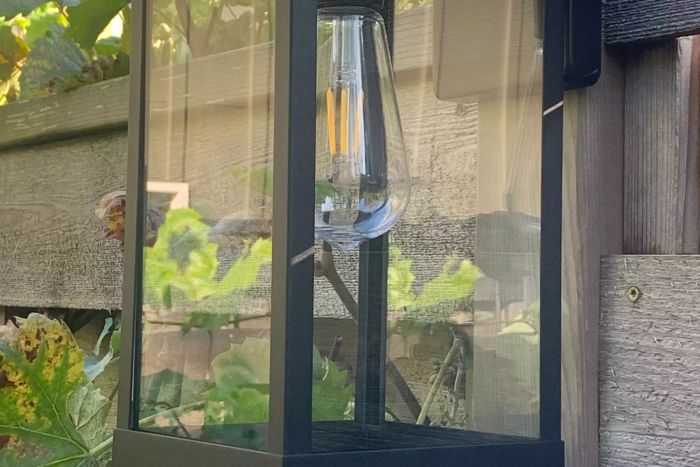 Better Homes & Gardens Solar Dusk-to-Dawn Decorative Outdoor LED Light mounted on a wall.