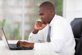 A businessman is using a laptop computer.