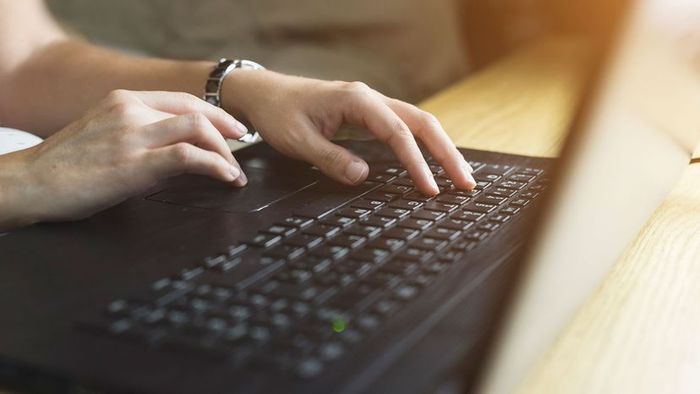 hands on a computer