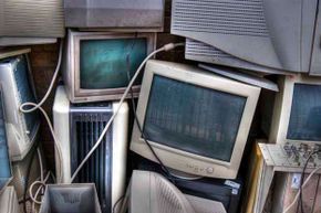 Old computer monitors piled up.