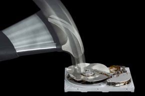 A hammer hitting a computer hard drive.