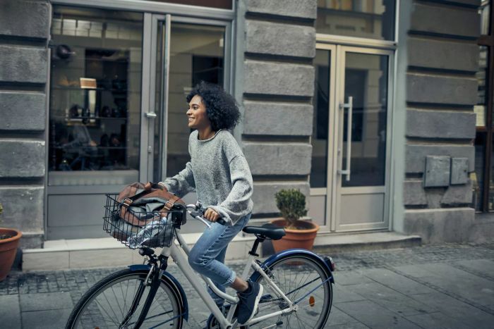Image: Woman riding a bike alone