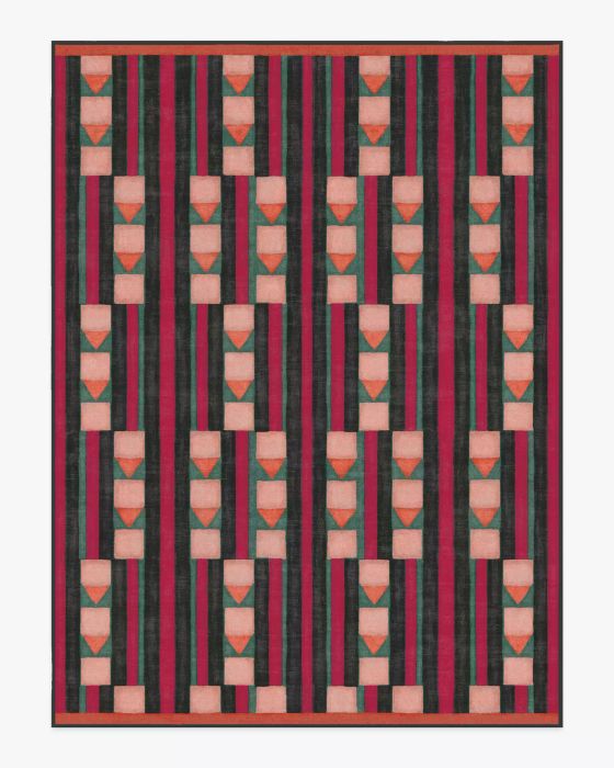 A rug featuring geometric shapes in a vibrant color palette of pink, green, and orange.