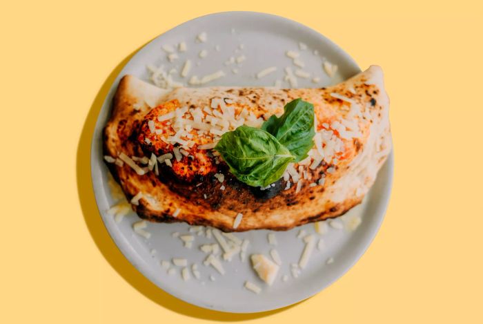 Traditional Calzone Napoletano - Stock Photo: Classic Pizza Napoletana with Calzone