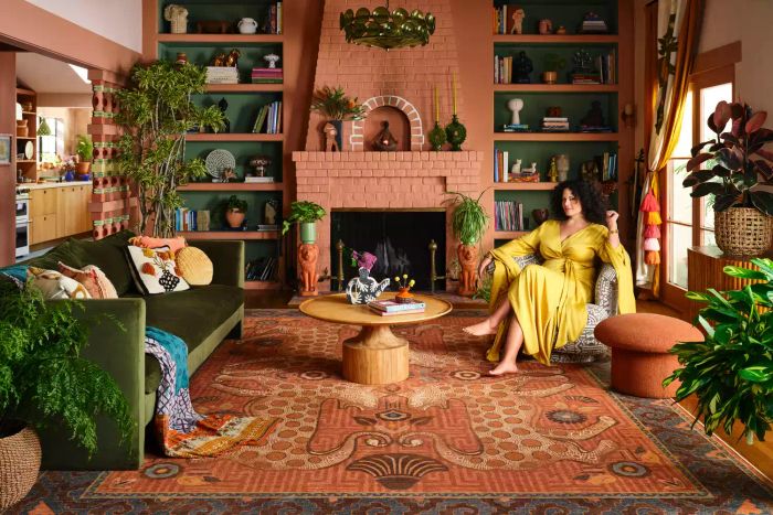 Justina Blakeney pictured in her living room with a stylish Ruggable rug underfoot