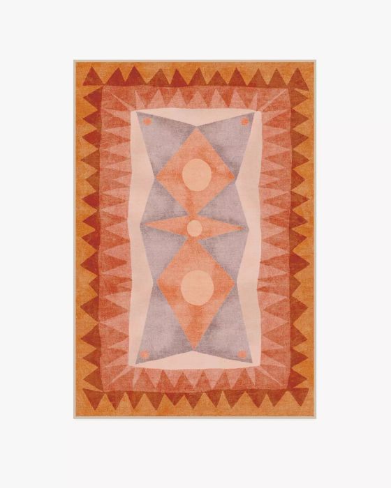 A rug featuring a geometric pattern in warm, sunset-inspired hues.