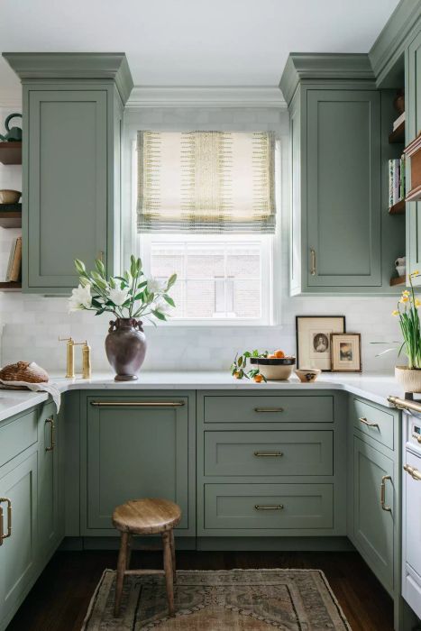 Roman shade in a kitchen with sage green cabinets and abundant natural light