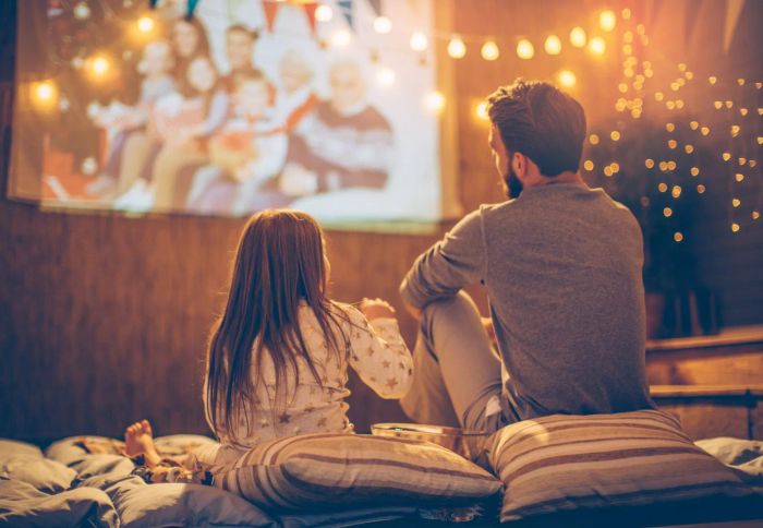 Father and Daughter Watching an Outdoor Movie